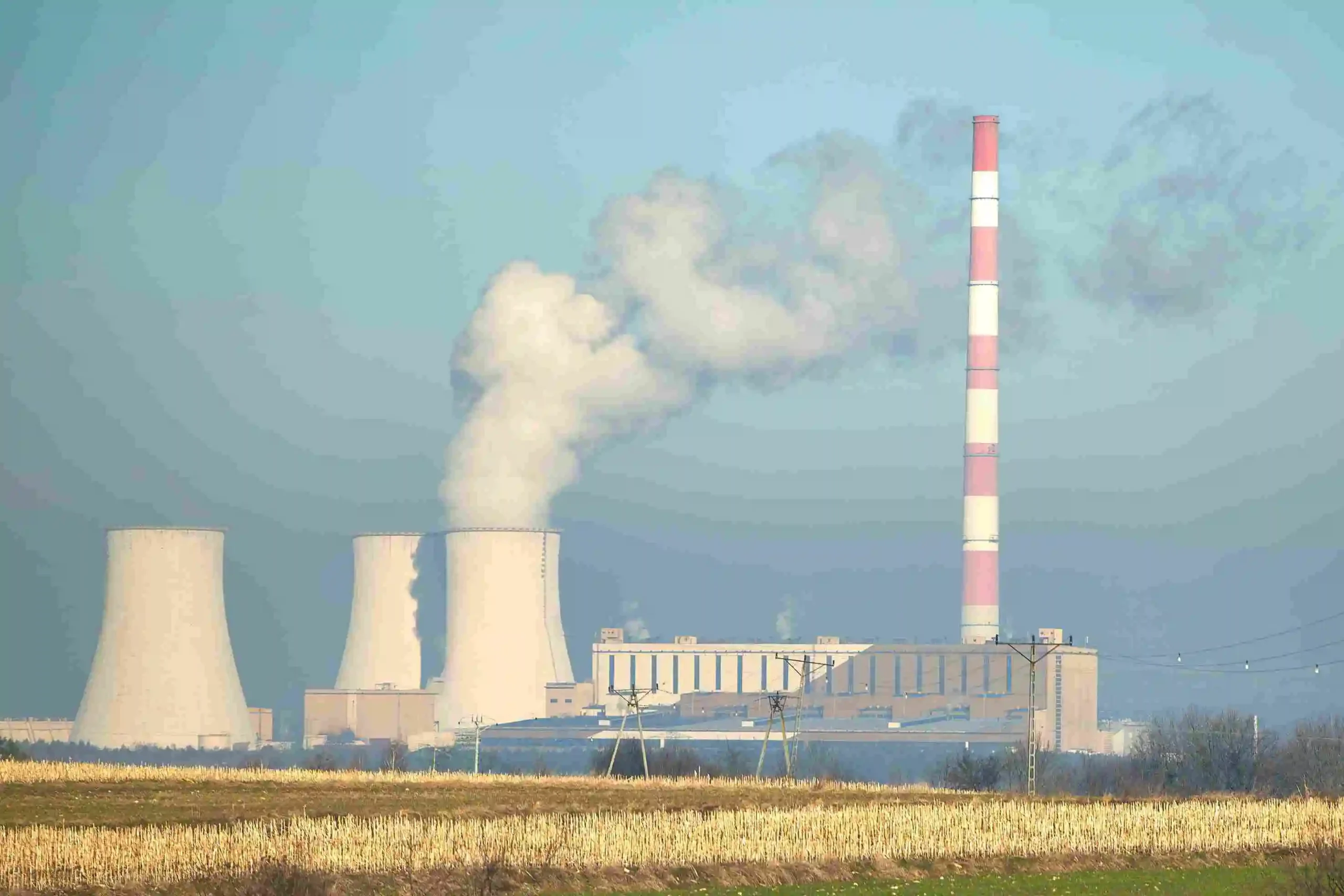 smoke-steam-rise-from-power-plant-green-field-blue-sky_11zon-_1_