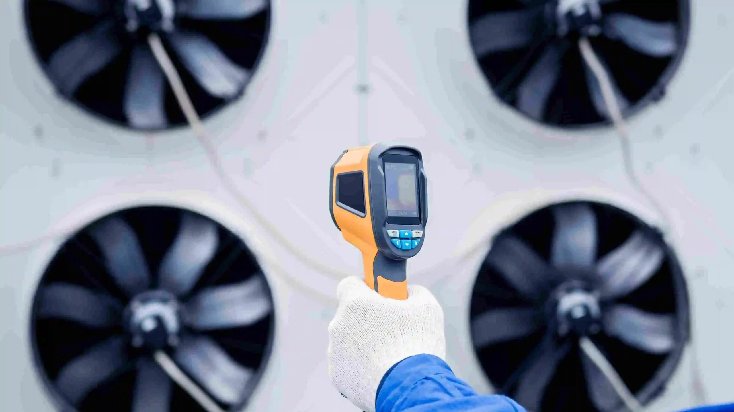technician-uses-thermal-imaging-infrared-thermometer-check-condensing-unit-heat-exchanger_11zon
